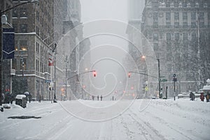 New York City Manhattan Midtown street under the snow during snow blizzard in winter. Empty 5th avenue with no traffic