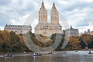 New York City, Manhattan. People rowing on boats in Central Park. Moody Autumn Lake Tourism