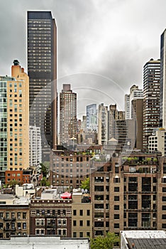 New York City midtown Manhattan skyline view with skyscrapers and cloudy sky in the day.