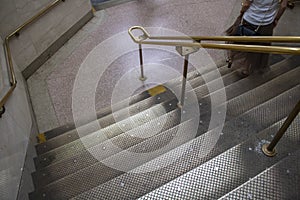 New york city public stairways to NYC underground woman going down