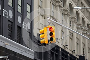 New York City`s yellow Traffic Light on background of skyscrapers. Red stop signal