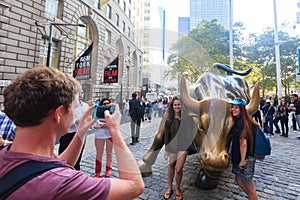 NEW YORK CITY - SEP 16: Charging Bull sculpture and tourists on