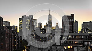 New York City skyline buildings nighttime view with glowing lights in the windows of apartments and offices in lower Manhattan