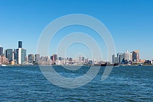 New York City Skyline and the East River with a Ship and the Queens New York Skyline