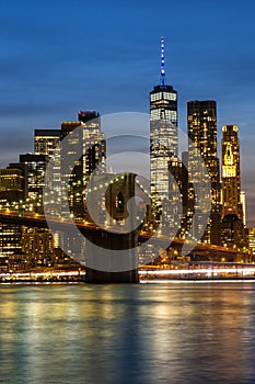 New York City skyline of Manhattan with Brooklyn Bridge and World Trade Center skyscraper at twilight portrait format in the