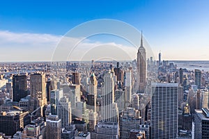 New York City Skyline in Manhattan downtown with Empire State Building and skyscrapers on sunny day with clear blue sky USA