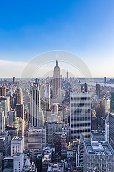 New York City Skyline in Manhattan downtown with Empire State Building and skyscrapers on sunny day with clear blue sky USA