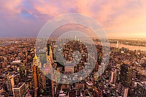 New York City skyline with Manhattan skyscrapers at dramatic stormy sunset, USA.