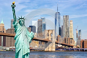 New York City skyline of Manhattan with Statue of Liberty, Brooklyn Bridge and World Trade Center photomontage in the United