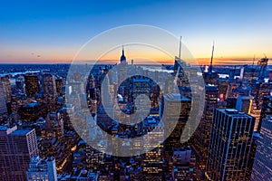 New York City skyline at night - skyscrapers of midtown Manhattan with Empire State Building at Amazing Sunset - USA