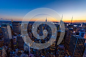 New York City skyline at night - skyscrapers of midtown Manhattan with Empire State Building at Amazing Sunset - USA