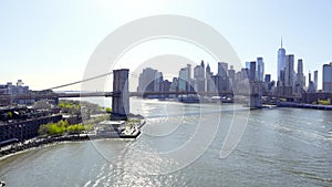 New York City skyline with skyscrapers. Brooklyn bridge over East River connecting Manhattan and Brooklyn