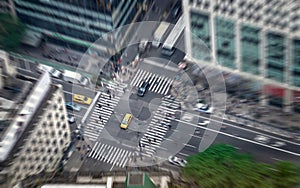 New York city street full of taxis, cars and pedestrians. Yellow cab in focus. Busy NYC Downtown.