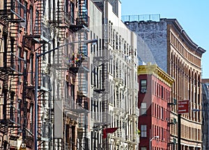 New York City style apartment buildings along Mott Street in the photo