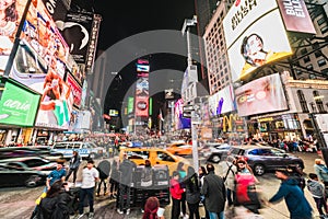 New York City, United States - Mar 31, 2019: Crowded people, car traffic transportation and billboards at Times Square