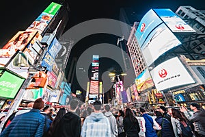 New York City, United States - Mar 31, 2019: Crowded people, car traffic transportation and billboards at Times Square