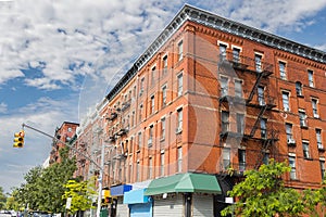 Red brick building with Fire Escape stairs on classic building wall in New York City