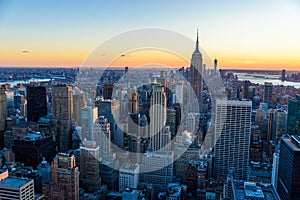 New York City - USA. View to Lower Manhattan downtown skyline with famous Empire State Building and skyscrapers at sunset.