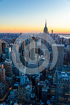 New York City - USA. View to Lower Manhattan downtown skyline with famous Empire State Building and skyscrapers at sunset.