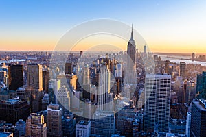 New York City - USA. View to Lower Manhattan downtown skyline with famous Empire State Building and skyscrapers at sunset.