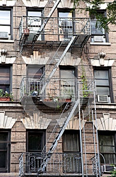 New York City Village apartment building with plants on the fire escape