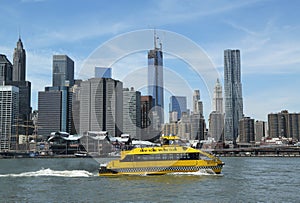 New York City Water Taxi with NYC skyline seen from Brooklyn Bridge Park