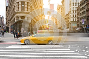 New York City yellow taxi cab in motion across broadway photo