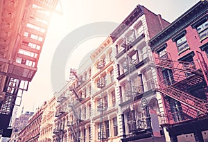 New York cityscape with old buildings with fire escapes, color toning applied, USA