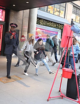 Salvation Army soldier performs for collections in midtown Manhattan.