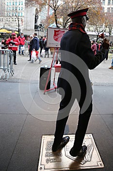 Salvation Army soldier performs for collections in midtown Manhattan.