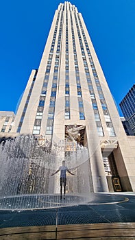 New York - A man standing in the middle of a water installation in front of Rockefeller Center