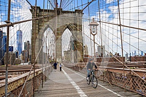 Bicyclists and pedestrians crossing empty Brooklyn Bridge during the coronavirus COVID-19 pandemic lockdown in New York City