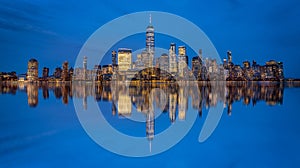 New York and New Jersey skyline from new jersey deck at sunset blue hour with reflection on hudson river