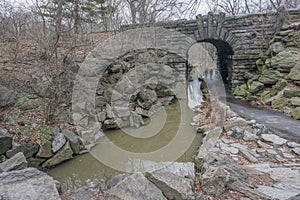 New York, New York: A stream flows under the Glen Span Arch, in the northwest section of Central Park