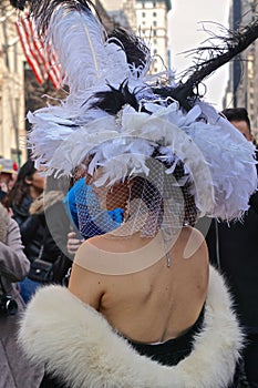 Woman wearing a black and white feathered hat and a fur-trimed stole at the Fifth Avenue Easter Parade