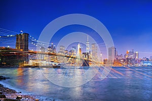 New York night view of the Lower Manhattan and the Brooklyn Bridge across the East River.