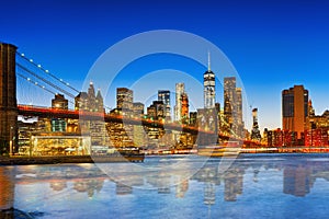 New York night view of the Lower Manhattan and the Brooklyn Bridge across the East River.