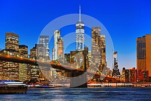 New York night view of the Lower Manhattan and the Brooklyn Bridge across the East River.