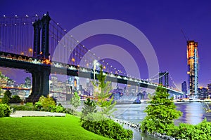 New York night view of the Lower Manhattan and the Manhattan Bridge across the East River.