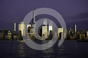 New York, NY / United States - A view of the World Trade Center and lower Manhattan at the Blue Hour. NYC skyline reflected in the