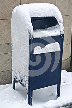 New York, NY, USA: Blue United States Postal Service mailbox covered in snow photo