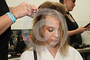 A model getting ready backstage before the Reem Acra Bridal show Fall/Winter 2018 Collection