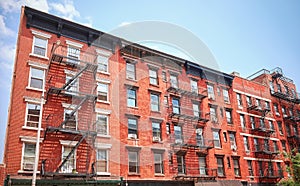 New York old red brick townhouses with iron fire escapes, USA