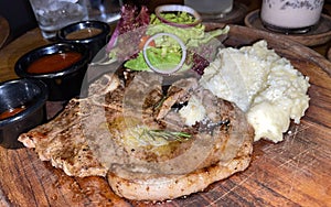 new york prime sirloin beef steak along with mash potatoes with delicious mushroom sauce and green salad onion