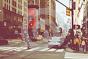 NEW YORK - SEPTEMBER 2, 2018: New York City street road in Manhattan at summer time, many cars, yellow taxis and busy people walk