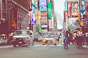 NEW YORK - SEPTEMBER 2, 2018: New York City street road in Manhattan at summer time, many cars, yellow taxis and busy people walk