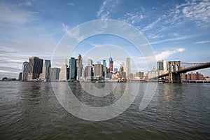 New york skyline reflection on the Hudson river at Brooklyn bridge at broad daylight