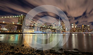 New york skyline reflection on the Hudson river at Brooklyn bridge at sunset