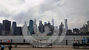 New York Skyline with viewers on bench