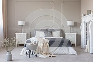 New york style bedroom interior with symmetric design, copy space on empty grey wall photo